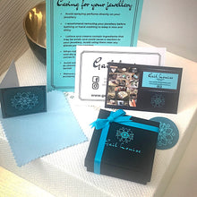 Load image into Gallery viewer, Solid sterling silver and gold earrings set with deep pink Rubies.